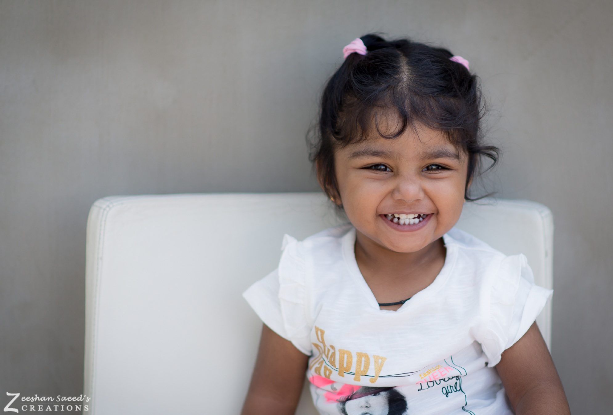 My daughter smiling in a white T-shirt