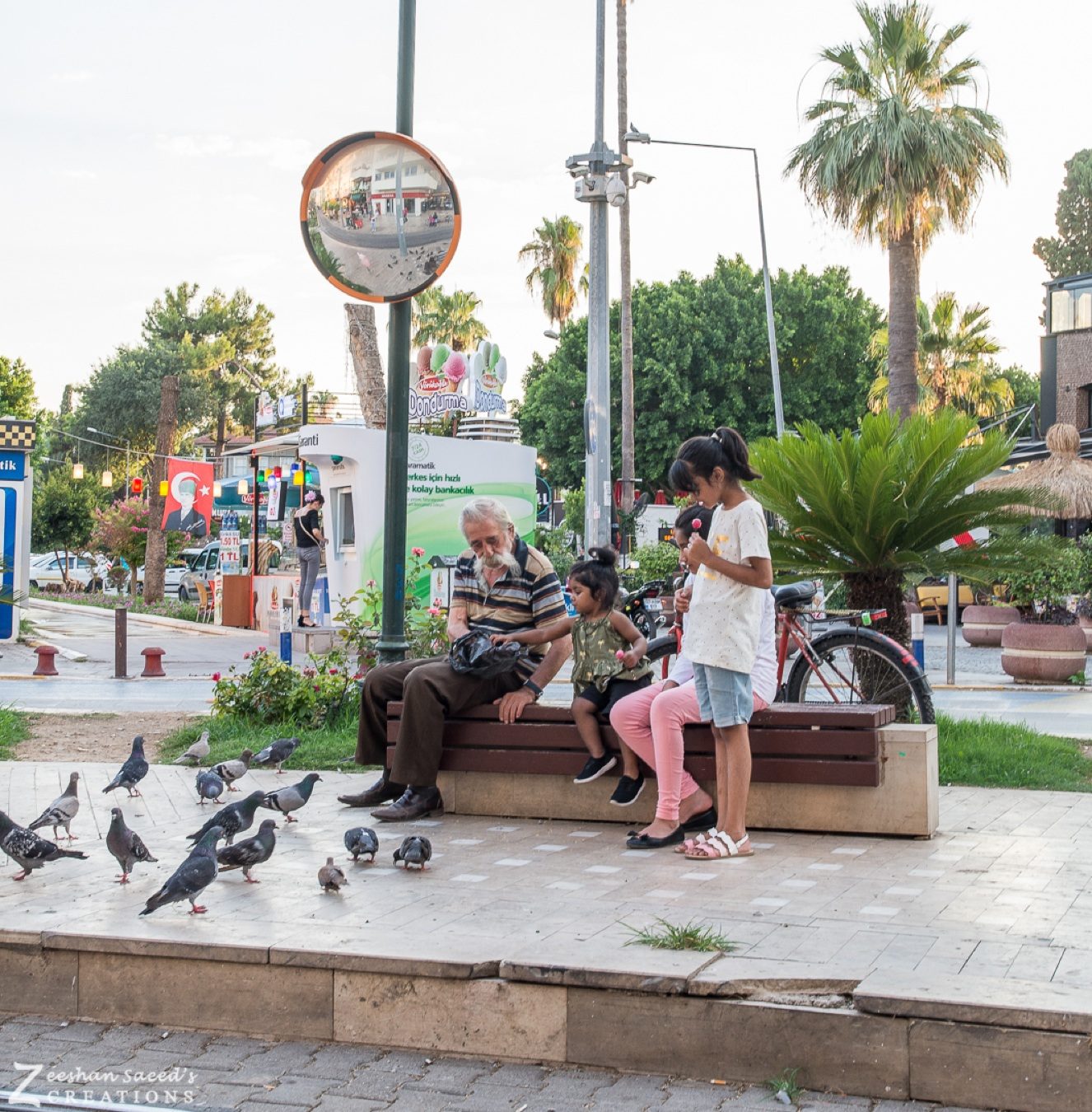 The kids join a local gentleman feeding the pigeons in Antalya