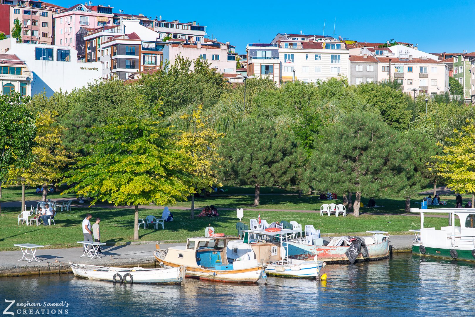 Boats moored by a waterside park on the Golden Horn