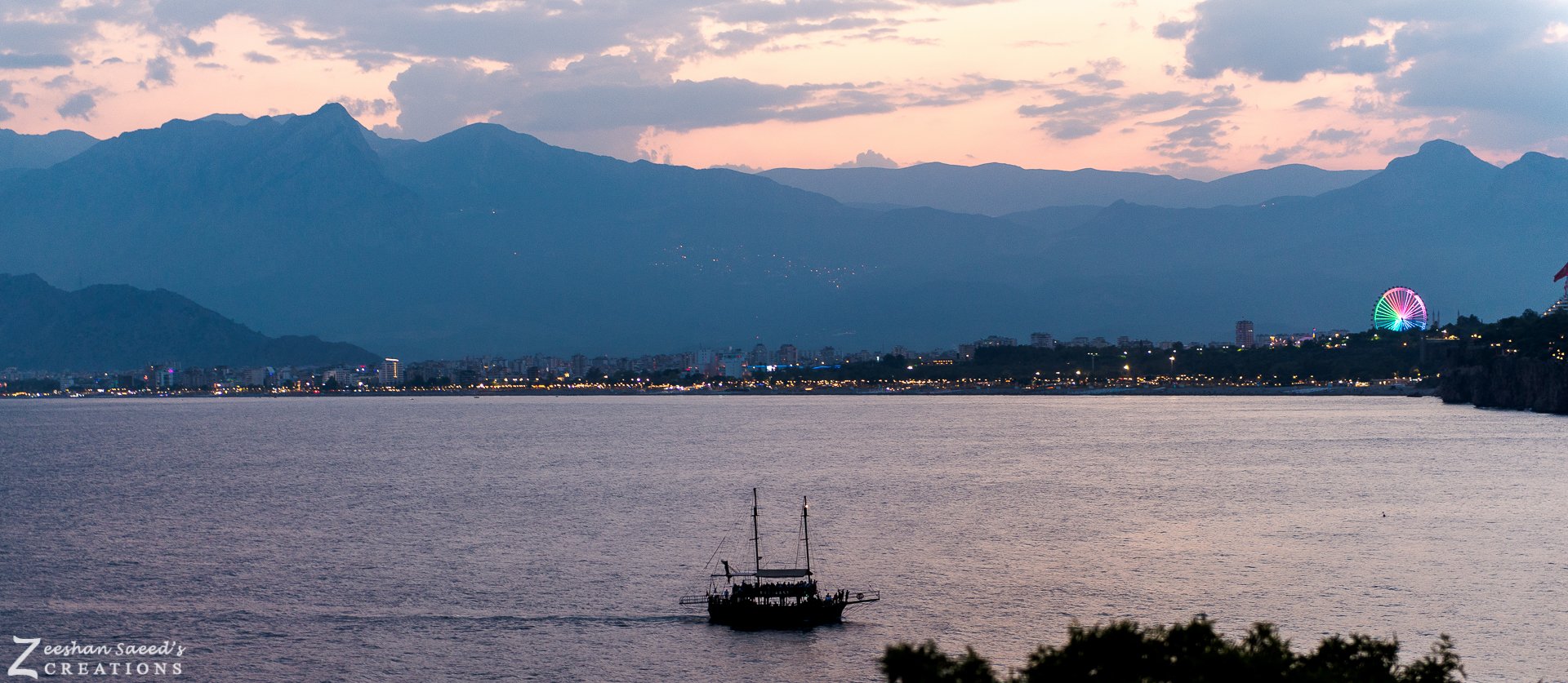A gulet crossing Antalya Bay at sunset