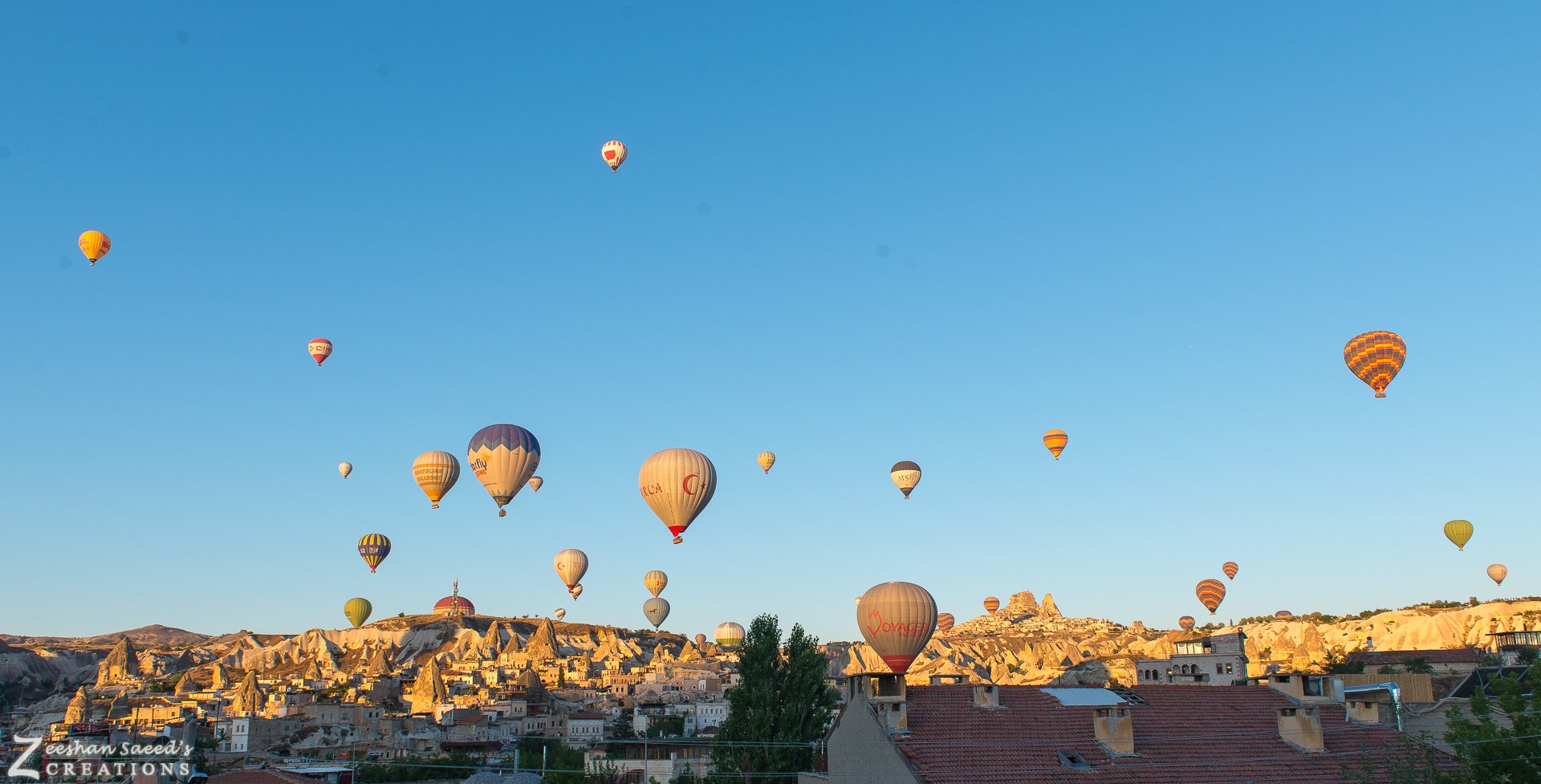 Balloons rising over Göreme at sunrise